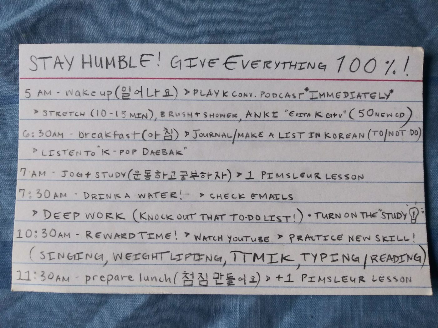 An index card headed Stay humble, give everything 100%, with a 5 AM daily plan for learning Korean