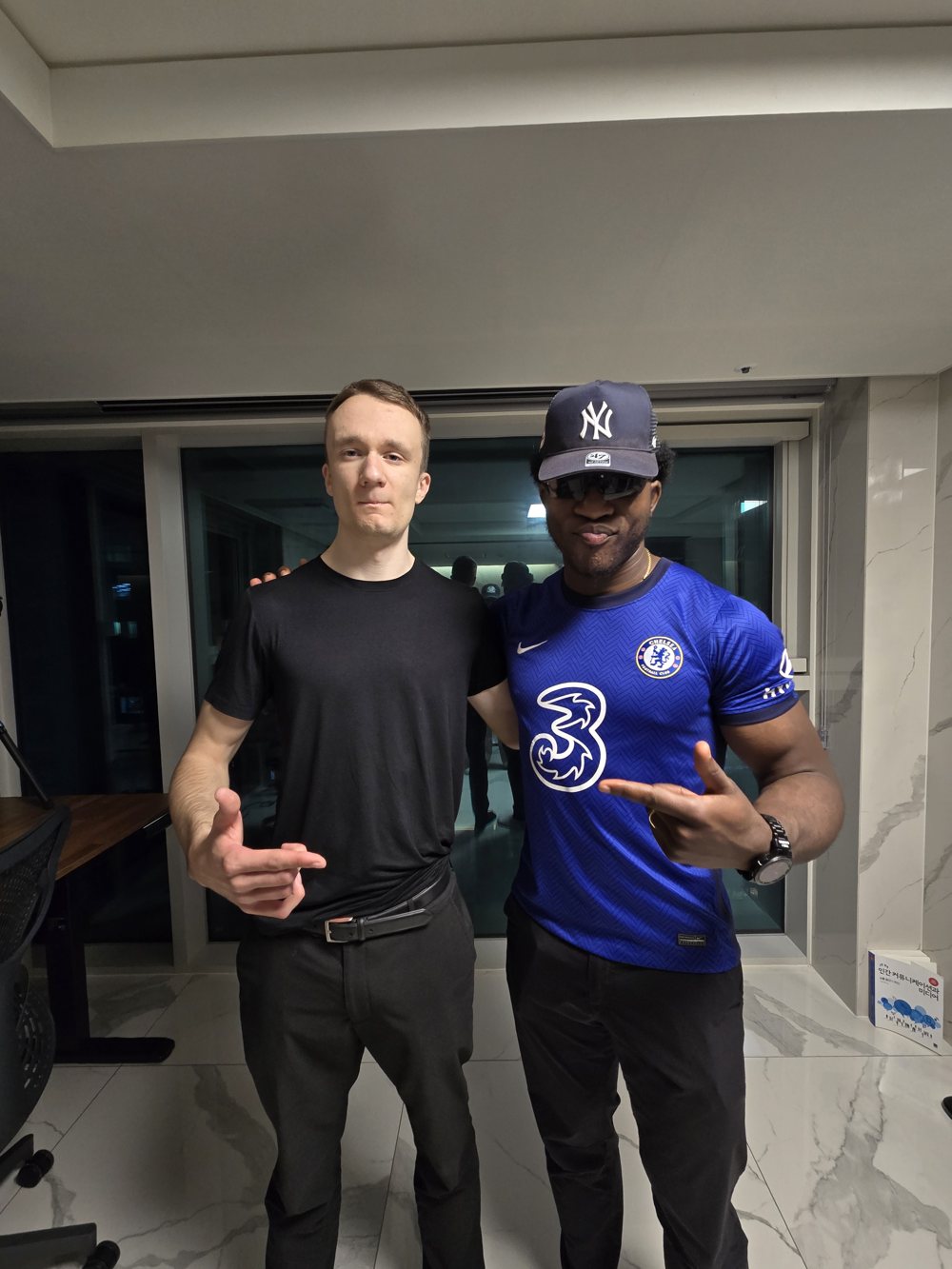 Ademola and George in Seoul, Ademola in a Chelsea jersey